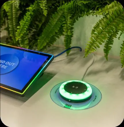 O.R.B beacon on a desk glowing green next to a booking tablet