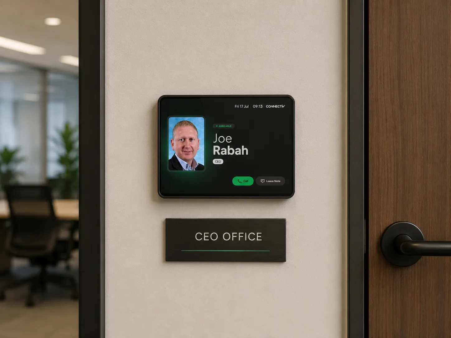 Presence display mounted beside a CEO office door showing the occupant as available